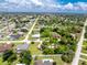 Aerial view highlights lush surroundings, and convenient street access, capturing the community's serene setting at 976 Great Falls Nw Ter, Port Charlotte, FL 33948