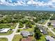 Expansive aerial view of a lush, green neighborhood with diverse homes and ample tree cover at 976 Great Falls Nw Ter, Port Charlotte, FL 33948