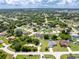 Wide aerial view showcasing the community's homes, green landscaping, and inviting atmosphere, complete with blue skies at 976 Great Falls Nw Ter, Port Charlotte, FL 33948