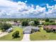 Aerial front view of a charming one story home, showcasing a well-manicured lawn and a welcoming facade at 976 Great Falls Nw Ter, Port Charlotte, FL 33948