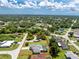 Aerial view showing the property with RV parking, pool, and landscaped grounds at 976 Great Falls Nw Ter, Port Charlotte, FL 33948
