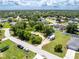 Aerial shot of RVs parked next to residential homes, surrounded by verdant greenery and blue sky with fluffy clouds at 976 Great Falls Nw Ter, Port Charlotte, FL 33948