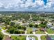 Sprawling aerial view showcasing a residential community with mature trees and diverse housing options at 976 Great Falls Nw Ter, Port Charlotte, FL 33948