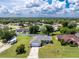 Aerial view highlighting the home's setting, lush landscaping, ample yard space, and RV parking at 976 Great Falls Nw Ter, Port Charlotte, FL 33948