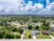 Aerial showcasing RV parking and the community's verdant, tree-lined streets at 976 Great Falls Nw Ter, Port Charlotte, FL 33948