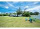 Open backyard includes RV parking, an outdoor seating area and privacy fence at 976 Great Falls Nw Ter, Port Charlotte, FL 33948