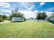 Expansive backyard with RV parking, seating area and white fence at 976 Great Falls Nw Ter, Port Charlotte, FL 33948