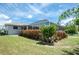 Backyard showcasing a lush lawn, privacy features, and screened-in patio, creating an idyllic outdoor retreat at 976 Great Falls Nw Ter, Port Charlotte, FL 33948
