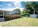 Backyard boasting mature trees, manicured lawn, and a screened-in patio, perfect for relaxation and entertaining at 976 Great Falls Nw Ter, Port Charlotte, FL 33948