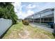 Spacious backyard with screened-in pool, manicured lawn, and privacy fence, creating a private outdoor oasis at 976 Great Falls Nw Ter, Port Charlotte, FL 33948