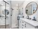 Renovated bathroom featuring modern vanity, stylish glass shower, and a wall mirror, creating a spa-like experience at 976 Great Falls Nw Ter, Port Charlotte, FL 33948