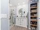 Renovated bathroom boasts a modern vanity, glass-enclosed shower, and convenient open shelving for ample storage at 976 Great Falls Nw Ter, Port Charlotte, FL 33948