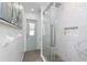 Bathroom features a glass shower with pebble floor and recessed storage space, enhancing convenience and luxury at 976 Great Falls Nw Ter, Port Charlotte, FL 33948