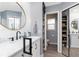 Tastefully designed bathroom with a double sink vanity, modern fixtures, open shelving and a glass enclosed shower at 976 Great Falls Nw Ter, Port Charlotte, FL 33948