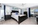 Comfortable bedroom featuring a ceiling fan, calming wall art and decor, and a sliding glass door to the patio at 976 Great Falls Nw Ter, Port Charlotte, FL 33948