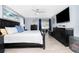 Comfortable bedroom featuring a ceiling fan, calming wall art and decor, and a sliding glass door to the patio at 976 Great Falls Nw Ter, Port Charlotte, FL 33948