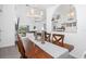 Dining room with wood table and chairs, stylish lighting, and open view to the living room at 976 Great Falls Nw Ter, Port Charlotte, FL 33948