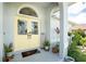 Charming entryway with decorative double doors, a transom window, and manicured landscaping at 976 Great Falls Nw Ter, Port Charlotte, FL 33948