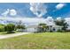 Charming home featuring a lush front lawn, a paved driveway, and RV parking at 976 Great Falls Nw Ter, Port Charlotte, FL 33948