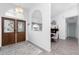 Inviting foyer leading to dining room and hallway, featuring a decorative light fixture and arched doorway at 976 Great Falls Nw Ter, Port Charlotte, FL 33948