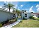 Charming home entrance featuring a light-colored exterior and meticulously landscaped front yard at 976 Great Falls Nw Ter, Port Charlotte, FL 33948