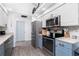 Stylish kitchen featuring stainless steel appliances and blue lower cabinets at 976 Great Falls Nw Ter, Port Charlotte, FL 33948