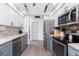 Kitchen featuring stainless appliances, modern cabinetry, and wood grain floors at 976 Great Falls Nw Ter, Port Charlotte, FL 33948