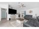 Bright living room featuring neutral decor, ceiling fan, and sliding glass doors to lanai at 976 Great Falls Nw Ter, Port Charlotte, FL 33948