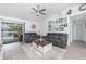Cozy living room with light-colored wood floors and comfortable seating near the screened-in lanai at 976 Great Falls Nw Ter, Port Charlotte, FL 33948