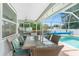 Covered patio with dining area, overlooking the pool at 976 Great Falls Nw Ter, Port Charlotte, FL 33948
