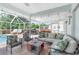 Spacious screened-in patio with outdoor seating and summer kitchen at 976 Great Falls Nw Ter, Port Charlotte, FL 33948
