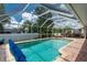 Screened-in pool with outdoor seating and grill, perfect for relaxing and entertaining at 976 Great Falls Nw Ter, Port Charlotte, FL 33948