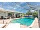 Enclosed pool area featuring a swimming pool, lounge chairs, and outdoor furniture perfect for entertaining at 976 Great Falls Nw Ter, Port Charlotte, FL 33948