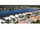Scenic aerial view showcasing waterfront homes in a peaceful community with mature trees and a tranquil lake at 10214 Arrowhead Dr, Punta Gorda, FL 33955