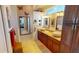Bathroom with double vanity, stone countertop, decorative mirrors and a large mirror at 10214 Arrowhead Dr, Punta Gorda, FL 33955