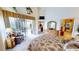 Tranquil Primary bedroom boasts a large bed, cozy armchair, and outdoor access to the lanai at 10214 Arrowhead Dr, Punta Gorda, FL 33955