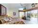 Bright bedroom with a large bed, comfortable armchair, and view of the lake at 10214 Arrowhead Dr, Punta Gorda, FL 33955
