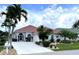 Charming single-story home features a red tile roof, mature landscaping, and a pristine driveway at 10214 Arrowhead Dr, Punta Gorda, FL 33955