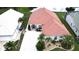 Aerial view of the home's roof, driveway, front yard landscaping, and proximity to adjacent homes at 10214 Arrowhead Dr, Punta Gorda, FL 33955