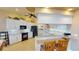 Stylish kitchen with white cabinets, black appliances, breakfast bar, and tile floors at 10214 Arrowhead Dr, Punta Gorda, FL 33955