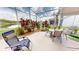 Outdoor seating arrangements and mature landscaping are featured in the screened-in lanai at 10214 Arrowhead Dr, Punta Gorda, FL 33955