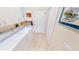 This home features a laundry room equipped with full-size, modern appliances, and a tiled floor at 10214 Arrowhead Dr, Punta Gorda, FL 33955