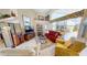 Bright living room featuring ample seating, tile floors, and expansive windows with views to the lanai at 10214 Arrowhead Dr, Punta Gorda, FL 33955