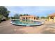 Resort-style community pool featuring a spacious deck and adjacent clubhouse, perfect for relaxation and recreation at 10214 Arrowhead Dr, Punta Gorda, FL 33955
