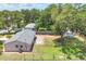 Aerial view of home showing the fenced backyard and the partial driveway with greenery, and utility shed at 1053 Yarmouth St, Port Charlotte, FL 33952