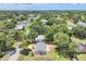 Aerial view showcases a charming home in neighborhood, lush greenery, and nearby homes at 1053 Yarmouth St, Port Charlotte, FL 33952