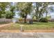 Well-manicured backyard featuring mature trees, a small shed, and a patio for outdoor relaxation and entertaining at 1053 Yarmouth St, Port Charlotte, FL 33952