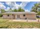 Spacious backyard featuring a well-kept lawn, patio area, and mature trees, perfect for outdoor living at 1053 Yarmouth St, Port Charlotte, FL 33952