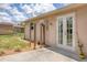 Cozy backyard featuring a concrete patio, a patch of grass, and a well-maintained exterior with French doors at 1053 Yarmouth St, Port Charlotte, FL 33952
