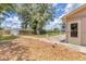 Large landscaped backyard featuring a shed, mature trees, and ample space for outdoor entertaining and relaxation at 1053 Yarmouth St, Port Charlotte, FL 33952